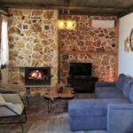 Cozy living room with fireplace and sofa in Apartment Smaro at Rustic House Embonas Rhodes