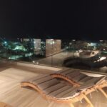 Rooftop terrace with sun loungers and night view over Embonas village at Rustic House Rhodes