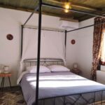 Elegant bedroom with canopy bed in Apartment Smaro at Rustic House Embonas Rhodes